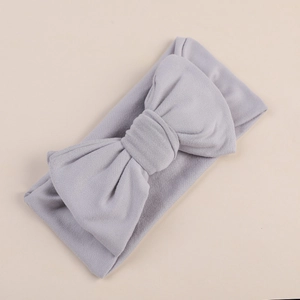 Detailed view of light grey infant headband with a large decorative double bow