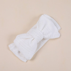 Detail of the white knitted hollow jacquard texture on a baby bow headband
