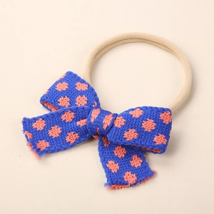 Macro shot of a floral knit bow baby headband with soft high-elastic nylon band