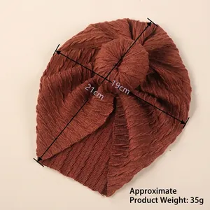 Brown knit donut turban baby hat measuring 21cm height and 19cm width for infants