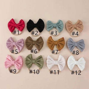 Detail of 12 colors of soft jacquard bow headbands with elastic nylon bands for babies