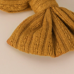 Soft nylon baby headband with a jacquard ginger yellow knit bow and textured finish