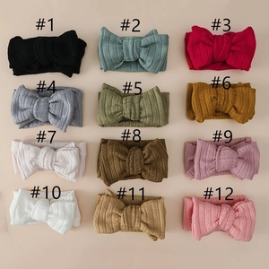 Detailed grid of 12 multi-colored ribbed knit baby headbands with elegant bows