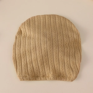 Knitted baby beanie with vertical rib and cable stitch texture in beige, windproof design