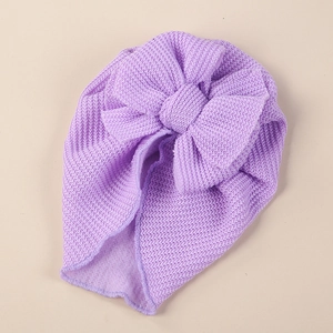Detail of baby knit turban hat with waffle texture and oversized bow in soft lavender