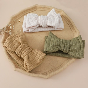 Three-piece set of knitted bow headbands for babies in pink, khaki, and olive green colors