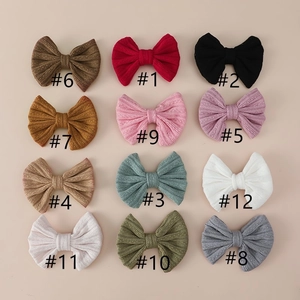 Detail view of jacquard bow hair clips for girls in 12 assorted solid colors