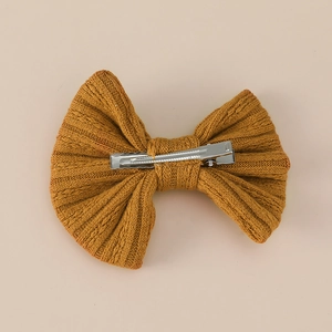 Knitted ginger yellow bow hair clip with textured rib pattern for girls
