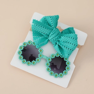 Detail of mint green lace bow headband and daisy sunglasses set for toddlers