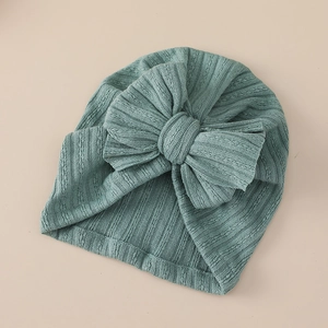 Detailed knit texture and oversized bow on a soft grey-green baby turban hat