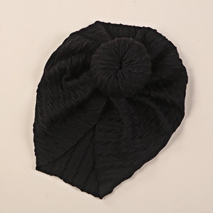 Detailed top view of black ribbed knit baby turban featuring a classic donut knot design