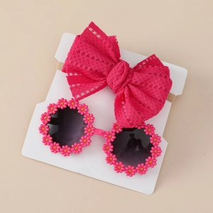 Detailed set featuring pink floral sunglasses and matching soft lace bow headband for babies
