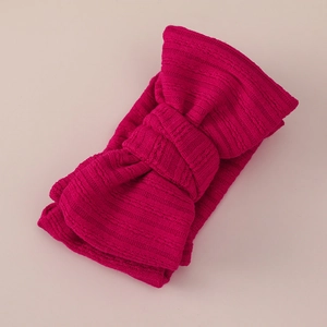 Detail view of hot pink ribbed knit baby headband with a stylish double layer bow