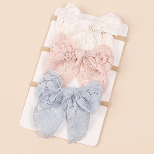 3-pack baby lace bow headbands in white pink and blue on a display card