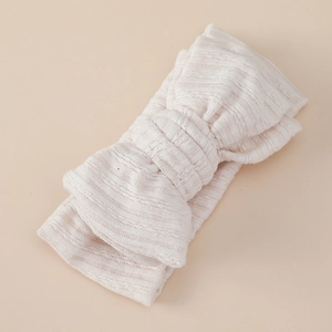 Detail of soft jacquard knitted double layer bow headband for infants and babies