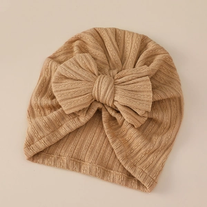 Close-up of ribbed texture and oversized bow on khaki baby turban winter hat