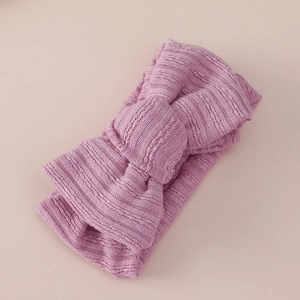 Detail of soft ribbed knit texture on a mauve pink double-layered baby bow headband