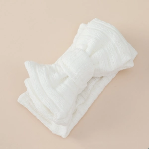 Detailed view of the soft white jacquard texture on a double-layer baby bow headband