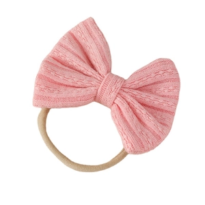 Pink jacquard bow headband for infants made of soft and stretchy nylon material