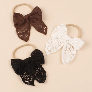 Detailed set of three lace bow headbands in black, white, and brown for baby girls