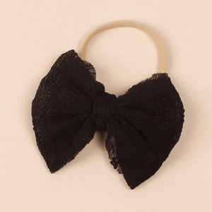 Detailed view of elegant black lace bow on a soft nylon elastic baby headband
