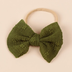 Close-up of baby nylon headband featuring a dark green mesh fabric bow with raw edges