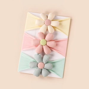 Three-piece set of baby flower headbands in soft yellow pink and green colors