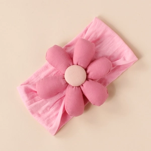 Detail of pink stuffed fabric flower headband for infants with high elastic knitted band