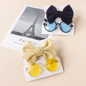 Detailed view of baby bow headbands and round sunglasses with cute decorative ears