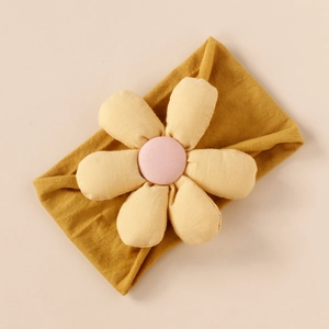 Detailed view of handmade soft fabric flower headband for babies in mustard and pink