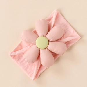 Detail of pink cotton baby headband with soft stuffed flower and green center