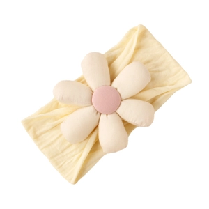 Pale yellow elastic baby headband with a 3D plush white flower and pink center