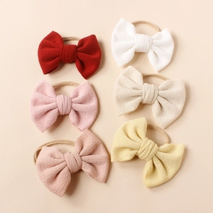 Set of six colorful knit fabric bow headbands with soft nylon bands for baby girls