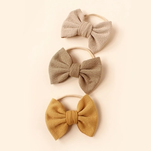 Three-piece set of corduroy bow headbands for babies in beige, coffee, and mustard yellow