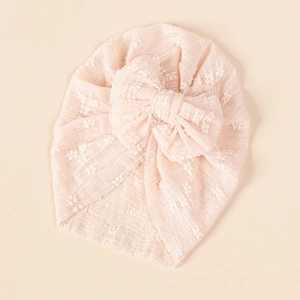 Detail view of baby turban hat with oversized mesh bow and soft lace texture