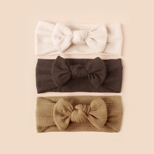 Three-pack of ribbed knit baby headbands with large bows in cream, coffee and khaki
