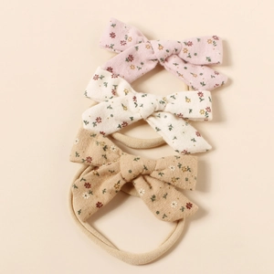 Detailliertes Set aus drei Baby-Stirnbändern mit floralen Baumwollschleifen in Pastelltönen