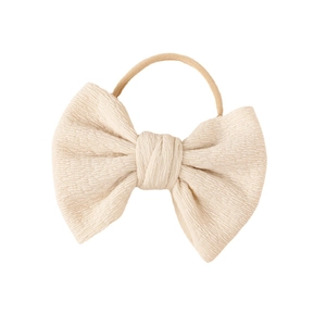 Soft cream knit bow headband for babies with high-elastic nylon band on white background