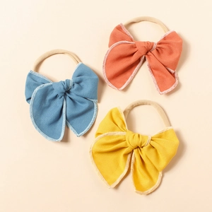 Lot de trois bandeaux pour bébé avec nœuds en lin colorés et nylon extensible