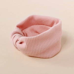Detail of baby pink ribbed knit headband with a decorative top knot for infants