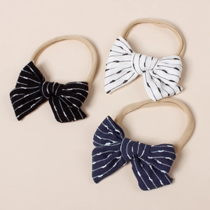 Detailed close-up of three striped baby bows with soft nylon elastic headbands