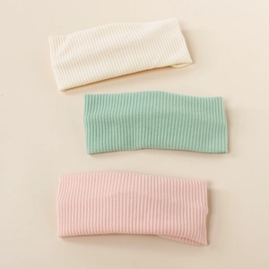 Three-pack of elastic ribbed baby headbands in beige, light green, and soft pink