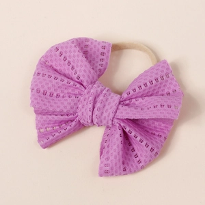 Detailed view of the purple mesh lace bow with high-elasticity nylon headband for infants