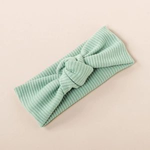 Detail of mint green ribbed knit fabric and knot design on the elastic baby headband
