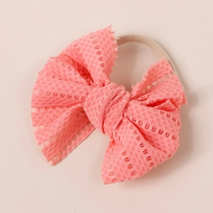Close-up of pink mesh bow headband with elastic seamless band for baby girls