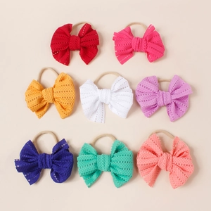 Detail view of 8-color set mesh bow baby headbands with soft elastic nylon skin-tone straps