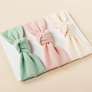 Three-piece set of knitted striped bow baby headbands in mint green, pink, and off-white