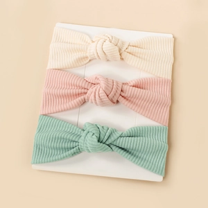 Three-pack ribbed knit baby headbands with top knots in cream, pink and mint green