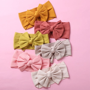 Set of 6 ribbed knit baby headbands with large bows in soft assorted pastel colors