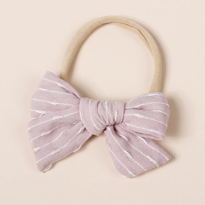 Detail of pink striped bow baby headband with soft high-elastic nylon band for infants
